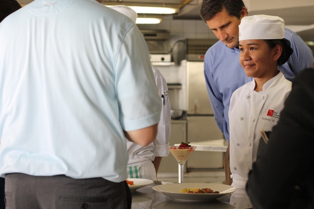 Student presents her specialty dish to Executive Chefs from Sea Pines Resort